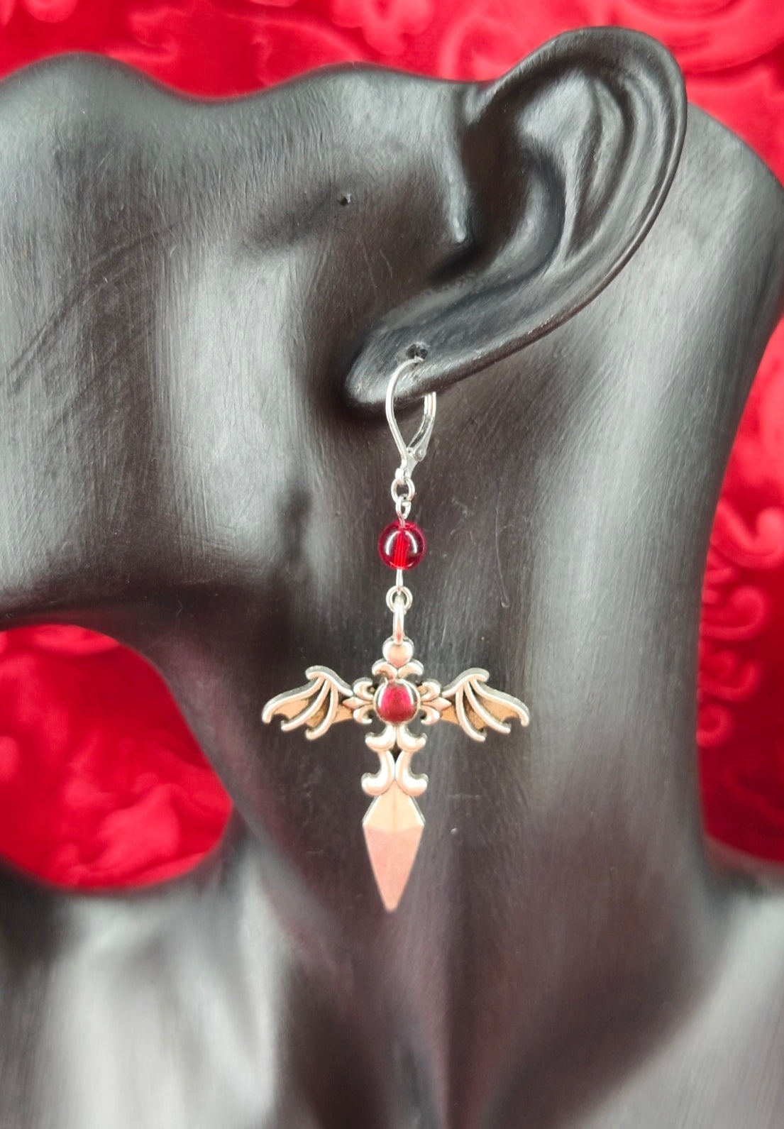 Paire de boucles d'oreilles épées ailés avec perles rouges fait main portées
