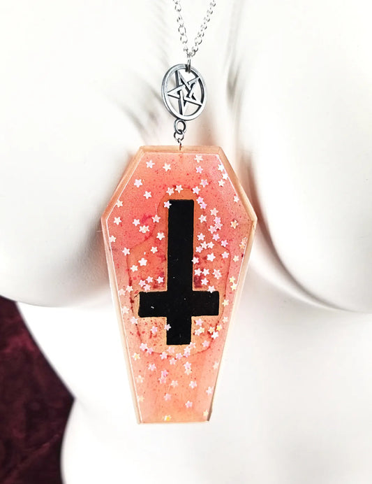 Détail du cercueil rose et de la croix du collier cercueil