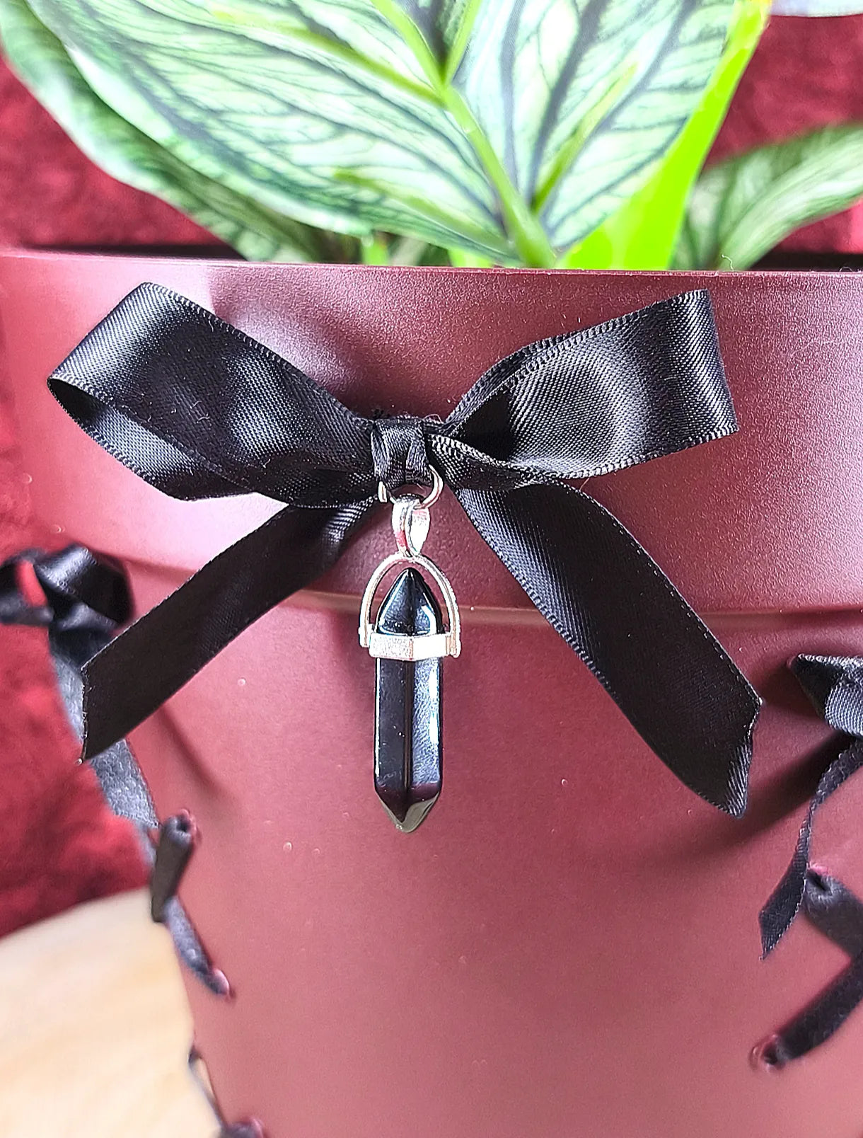 Détail du noeud en satin et du cristal noir